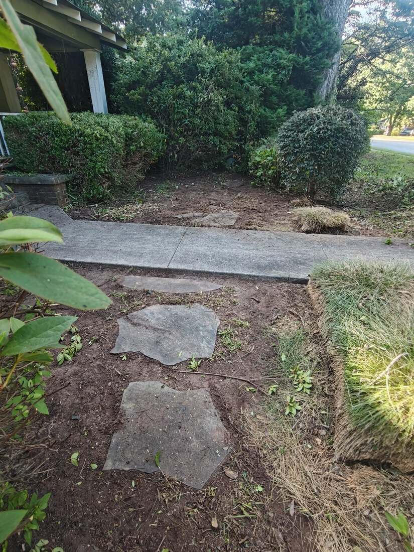 Side bed cleared down to bare soil around stepping stones at a Winterville, GA home